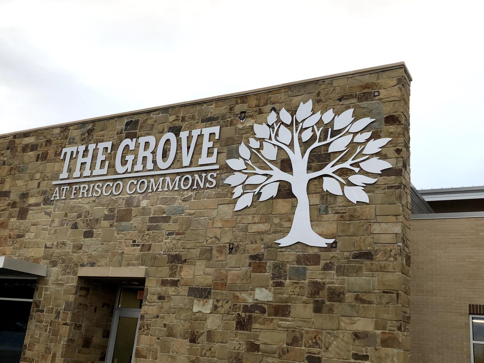 Cut letters and tree logo on stone