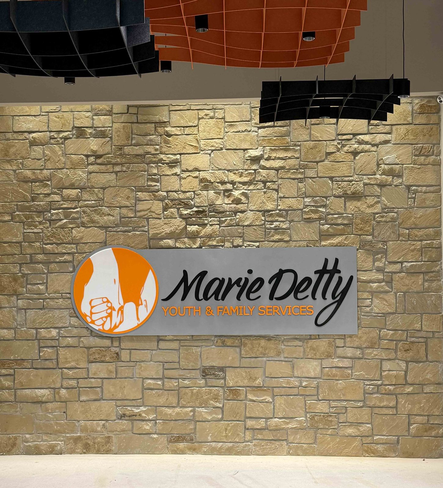 Push-thru letters and logo on stone