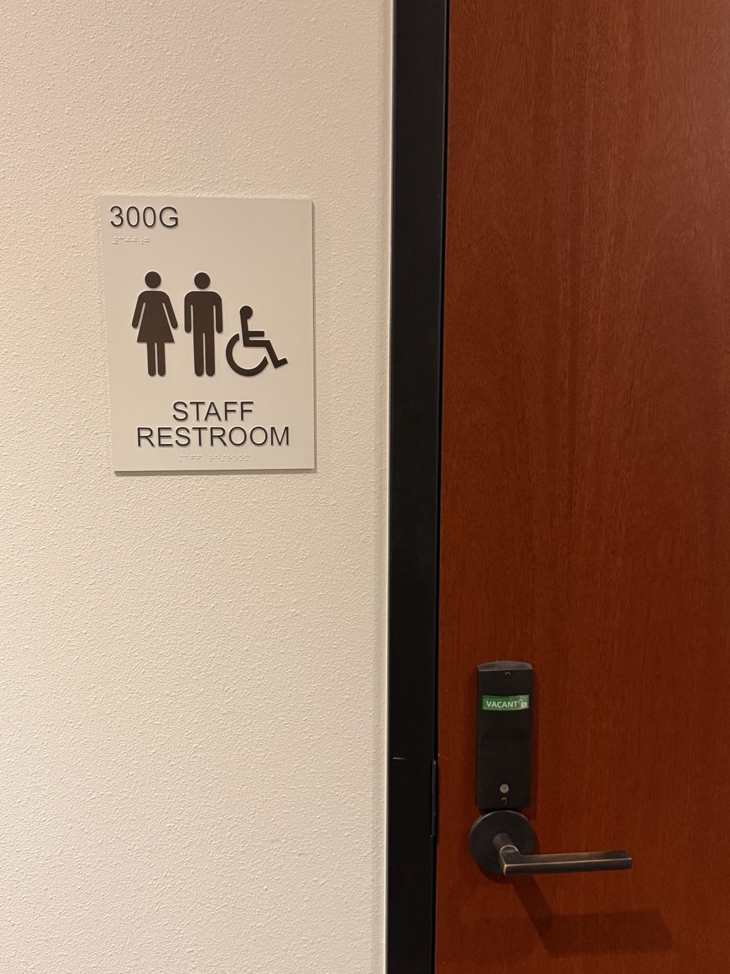 ADA restroom sign with tactile and braille